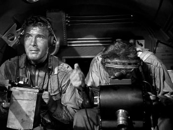 Two men are sitting in an airplane cockpit