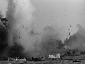 Movie still from “Air Force” (1943), directed by Howard Hawks – Smoke billows from a boat in the water; Extreme Wide shot, High angle