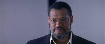 A person wearing glasses and a suit