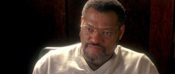 A person wearing glasses and a sweater