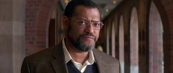 A person wearing glasses and a suit
