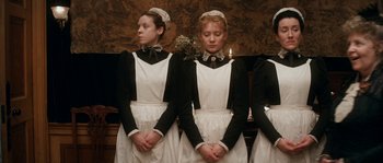 Movie still from “Albert Nobbs” (2011), directed by Rodrigo García – A group of young women dressed in maid outfits; Medium shot, Low angle