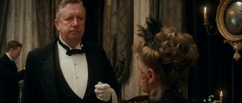Movie still from “Albert Nobbs” (2011), directed by Rodrigo García – A man and a woman in formal wear talking to each other; Medium shot, Over the shoulder angle