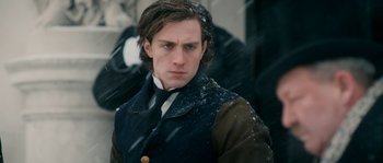 Movie still from “Albert Nobbs” (2011), directed by Rodrigo García – A man in a suit and tie standing in the snow; Close Up shot, Over the shoulder angle