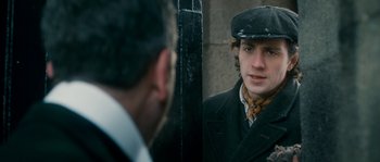 Movie still from “Albert Nobbs” (2011), directed by Rodrigo García – A man in a hat looking at himself in a mirror; Close Up shot, Over the shoulder angle