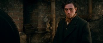 Movie still from “Albert Nobbs” (2011), directed by Rodrigo García – A man standing in front of a brick wall; Close Up shot, Over the shoulder angle