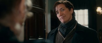 Movie still from “Albert Nobbs” (2011), directed by Rodrigo García – A woman in a black jacket and a black scarf; Close Up shot, Over the shoulder angle