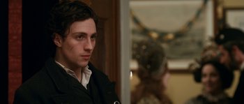 Movie still from “Albert Nobbs” (2011), directed by Rodrigo García – A man in a black jacket is looking at the camera; Close Up shot, Over the shoulder angle