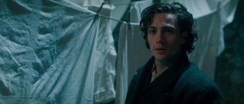 Movie still from “Albert Nobbs” (2011), directed by Rodrigo García – A man standing in front of a clothesline in a room; Close Up shot, Over the shoulder angle