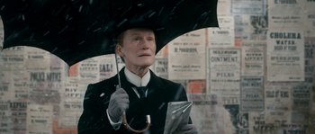 Movie still from “Albert Nobbs” (2011), directed by Rodrigo García – An old man holding an umbrella in the rain; Close Up shot, Low angle