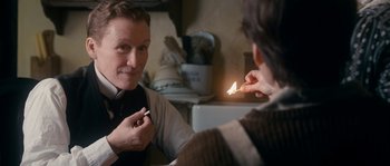 Movie still from “Albert Nobbs” (2011), directed by Rodrigo García – A man is putting on a bow tie in front of a mirror; Close Up shot, Over the shoulder angle