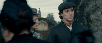 Movie still from “Albert Nobbs” (2011), directed by Rodrigo García – A man and a woman standing next to each other in a cemetery; Close Up shot, Low angle