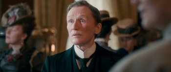 Movie still from “Albert Nobbs” (2011), directed by Rodrigo García – A person wearing a suit and tie; Close Up shot, Low angle