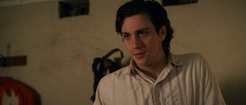 Movie still from “Albert Nobbs” (2011), directed by Rodrigo García – A man with long dark hair wearing a white shirt; Close Up shot, Over the shoulder angle