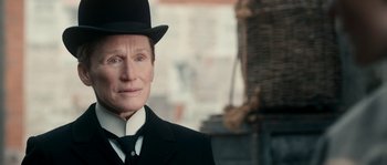 Movie still from “Albert Nobbs” (2011), directed by Rodrigo García – An older man wearing a top hat and a suit; Close Up shot, Over the shoulder angle