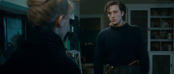 Movie still from “Albert Nobbs” (2011), directed by Rodrigo García – A man in a black sweater is looking at himself in the mirror; Medium shot, Over the shoulder angle