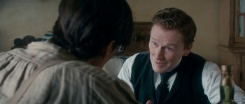 Movie still from “Albert Nobbs” (2011), directed by Rodrigo García – A man in a vest talking to a woman in a dress shirt; Close Up shot, Over the shoulder angle