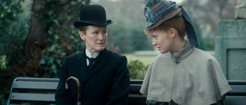Movie still from “Albert Nobbs” (2011), directed by Rodrigo García – A man and a woman wearing hats sitting next to each other; Close Up shot, Over the shoulder angle
