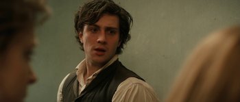 Movie still from “Albert Nobbs” (2011), directed by Rodrigo García – A man with long hair and a white shirt; Close Up shot, Over the shoulder angle