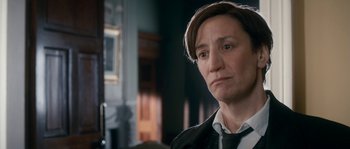 Movie still from “Albert Nobbs” (2011), directed by Rodrigo García – A woman with short brown hair wearing a black jacket; Close Up shot, Over the shoulder angle