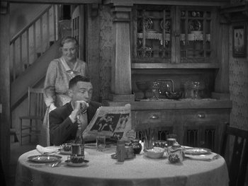 Movie still from “Alice Adams” (1935), directed by George Stevens – An older man and woman sitting at a dinner table; Medium shot, High angle