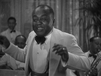 Movie still from “Alice Adams” (1935), directed by George Stevens – A black and white photo of a man in a tuxedo; Medium shot, High angle