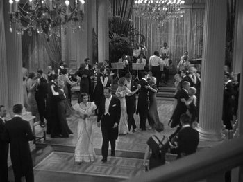 Movie still from “Alice Adams” (1935), directed by George Stevens – A black and white photo of people in formal wear dancing; Wide shot, High angle