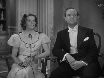 Movie still from “Alice Adams” (1935), directed by George Stevens – A man and a woman sitting next to each other in formal wear; Medium shot, Low angle
