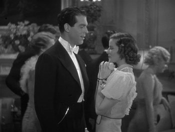 Movie still from “Alice Adams” (1935), directed by George Stevens – A man and a woman standing next to each other; Medium shot, High angle