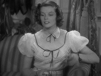 Movie still from “Alice Adams” (1935), directed by George Stevens – A black and white photo of a woman in a white blouse; Medium shot, High angle