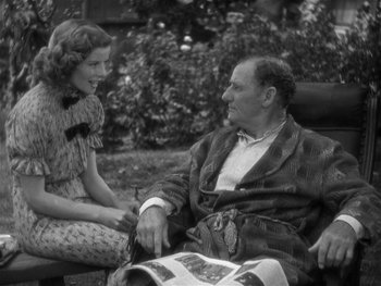 Movie still from “Alice Adams” (1935), directed by George Stevens – An older man sitting next to a young woman; Medium shot, High angle
