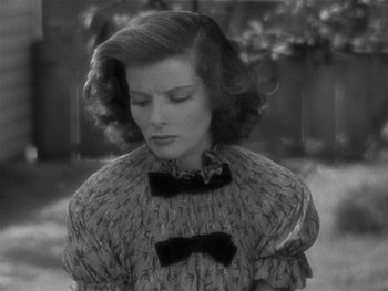 Movie still from “Alice Adams” (1935), directed by George Stevens – A black and white photo of a woman in a sweater; Close Up shot, High angle