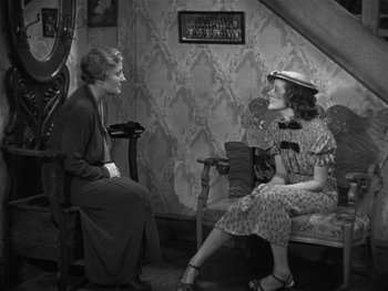 Movie still from “Alice Adams” (1935), directed by George Stevens – Two women are sitting on a chair and talking to each other; Wide shot, High angle
