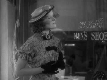 Movie still from “Alice Adams” (1935), directed by George Stevens – A woman wearing a hat , gloves , and a dress; Medium shot, Low angle