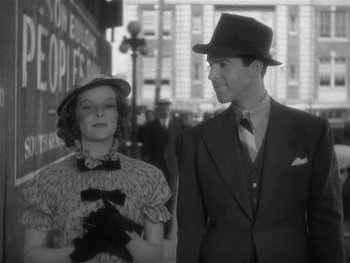 Movie still from “Alice Adams” (1935), directed by George Stevens – A man and a woman standing next to each other on the street; Medium shot, Low angle