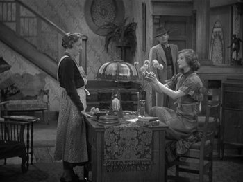 Movie still from “Alice Adams” (1935), directed by George Stevens – Two women and a man are standing around a table; Wide shot, High angle