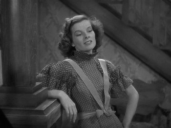 Movie still from “Alice Adams” (1935), directed by George Stevens – An old black and white photo of a woman leaning on a railing; Medium shot, Low angle