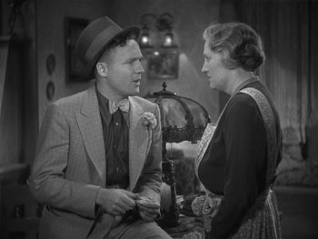 Movie still from “Alice Adams” (1935), directed by George Stevens – A man and a woman are talking to each other; Medium shot, High angle