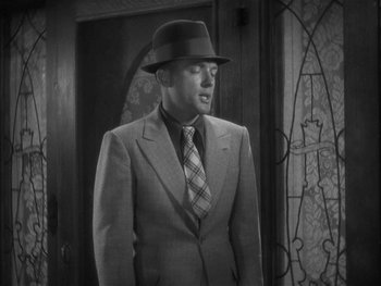 Movie still from “Alice Adams” (1935), directed by George Stevens – A black and white photo of a man in a suit and tie; Medium shot, Low angle