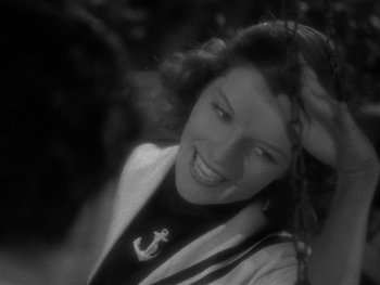 Movie still from “Alice Adams” (1935), directed by George Stevens – A black - and - white photo of a woman smiling; Close Up shot, High angle