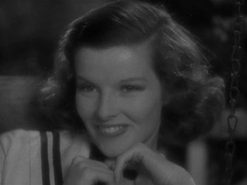 Movie still from “Alice Adams” (1935), directed by George Stevens – A black - and - white photo of a woman smiling for the camera; Close Up shot, High angle