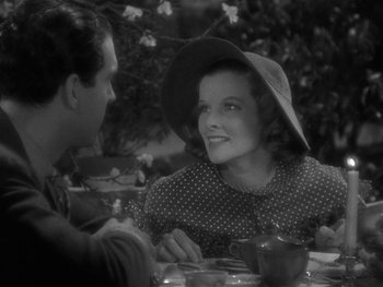 Movie still from “Alice Adams” (1935), directed by George Stevens – An old photo of two people sitting at a table; Medium shot, Over the shoulder angle
