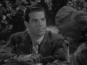 Movie still from “Alice Adams” (1935), directed by George Stevens – A black and white photo of a man in a suit and tie; Close Up shot, Over the shoulder angle