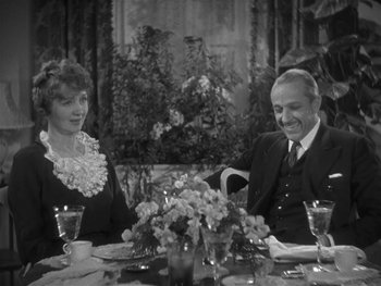 Movie still from “Alice Adams” (1935), directed by George Stevens – An older couple sitting at a dinner table; Medium shot, High angle