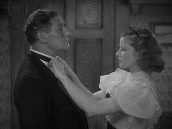 Movie still from “Alice Adams” (1935), directed by George Stevens – A man and a woman adjusting their neck ties; Medium shot, High angle