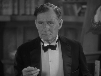 Movie still from “Alice Adams” (1935), directed by George Stevens – An older man in a tuxedo is smoking a cigarette; Close Up shot, High angle