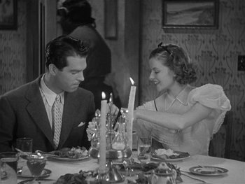 Movie still from “Alice Adams” (1935), directed by George Stevens – A man and a woman sitting at a dinner table; Medium shot, High angle