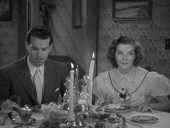 Movie still from “Alice Adams” (1935), directed by George Stevens – A man and a woman sitting at a dinner table; Medium shot, High angle