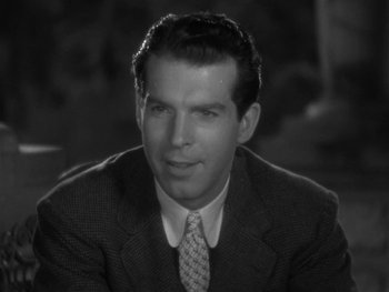 Movie still from “Alice Adams” (1935), directed by George Stevens – A man wearing a suit and tie sitting in a room; Close Up shot, High angle