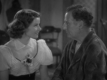Movie still from “Alice Adams” (1935), directed by George Stevens – An old photo of a man and a woman talking to each other; Close Up shot, Over the shoulder angle
